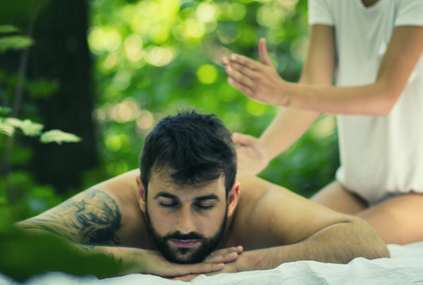 man getting back massage in the forest