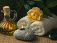 candle towel yellow rose and massage oil arrangement